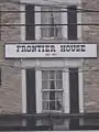 The official title of the house located between two windows on the front of the structure.