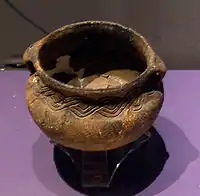 A small pot with guilloché designs