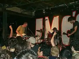 Fugazi performing at Emo's in 2002, left to right: Ian MacKaye, Brendan Canty, Guy Picciotto. (Not pictured: Joe Lally.)