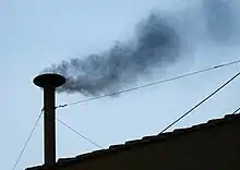 Black smoke coming from the Sistine Chapel chimney before the election of Pope Benedict XVI