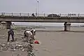 Digging for jade under the G315 Highway bridge over the Hotan River