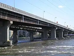 Two non-identical box girder bridges over rapids.