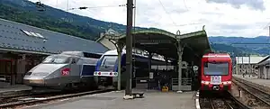 Three different train types at a station