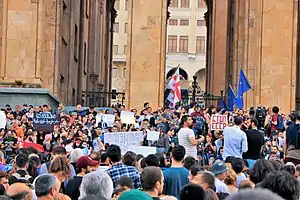 Protesters are holding signs "don't shoot" and "stop USSR".