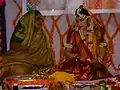 Bride with floral decorations for Haldi, Mehandi or Sangeet ceremony, part of pre-wedding rituals in South Asia.