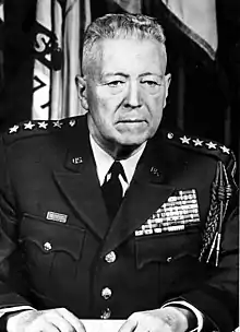 An aged Caucasian man in military uniform, with a large number of ribbons and medals