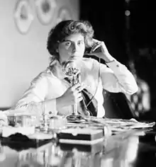 An American candlestick telephone being used by Genevieve Clark Thomson, circa 1915.