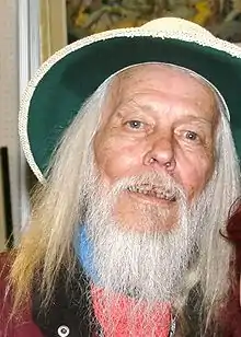 A man with a white beard and a hat.