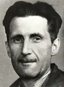 A close-up photograph of a man with a mustache