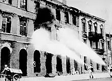 Black and white photograph of German units using flame-throwers to burn down Warsaw's ruins