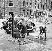 Women doing their wash at a cold water hydrant in a Berlin street, July 1945.