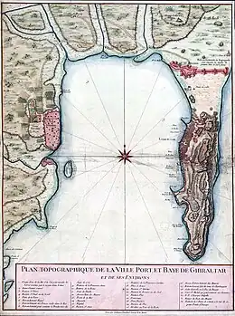 A map depicting a semi-circular bay. On the right shore is a large town and on the left shire is a smaller town. Along the voast are rivers and fields.