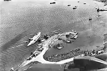 MV Anshun lying on her side at Gili Gili Dock, in Milne Bay, New Guinea, 1942