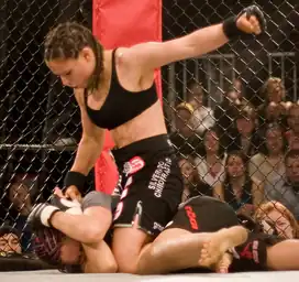 Image 11Gina Carano applying a ground-and-pound on her opponent. (from Mixed martial arts)