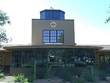 photo of the administrative building of the Thunderbird School of Global Management, featuring the historical control tower from the 1940s airfield on which it was built.