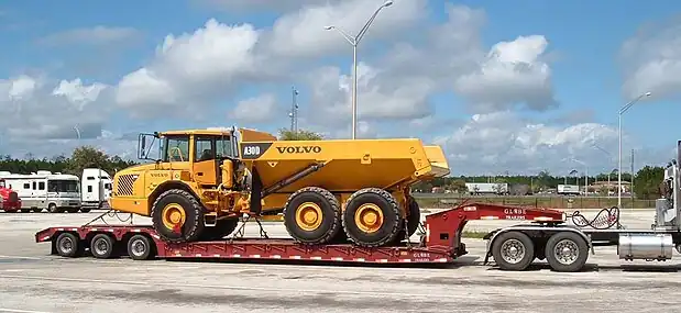 A lowboy trailer carrying a truck