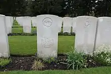 A colour photograph of several grave headstones, with Ward's in the middle of the image