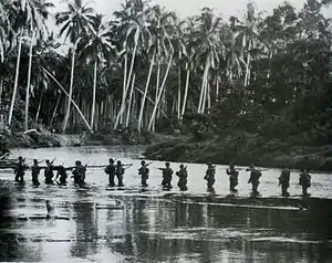 A U.S. Marine patrol crosses the Matanikau River on Guadalcanal in September 1942