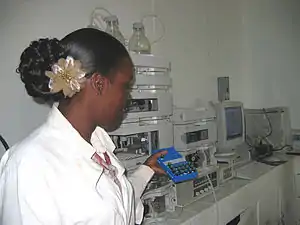 Image 11A technician at the Guyana Food and Drug Department Laboratory in Georgetown, Guyana selecting peanut samples to be tested with new equipment. (from Agriculture in Guyana)