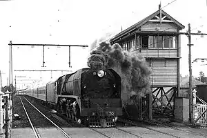 H 220 leads the northbound Albury Express past the signal box at Essendon, circa 1949