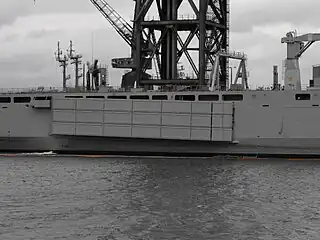 A Mexeflote suspended from the starboard flank of HMAS Choules