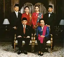 Image 30Formal family portrait of former Indonesian's President B.J. Habibie. Women wear kain batik and kebaya with selendang (sash), while men wear jas and dasi (western suit with tie) with peci cap. (from Culture of Indonesia)