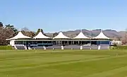 view of cricket stand in front of a pavilion