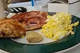 Ham and eggs served with scrambled eggs