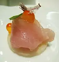 A Japanese-influenced amuse-bouche: hamachi, salmon roe, basil, basil flower.