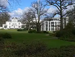 A large building with trees in front