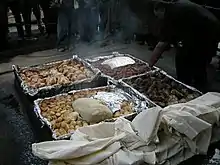 A Hāngi being prepared, a New Zealand Māori method of cooking food for special occasions using hot rocks buried in a pit oven.