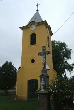 Bell tower with stone cross in Böhönye