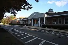 The front building facade of Harry Lee Cole School.  The building is a red brick building.