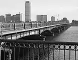Bridge viewed from the upstream Cambridge side in 1985.  Construction barrels restricting traffic from the outside lanes, and general wear and tear are visible (click on image to enlarge)