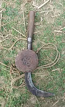 Nepali sicle (hasiya) with its carrier (khurpeto) carved with the Aryan Star/Flower of Life symbol