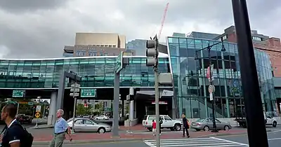 A side view of a glass-covered elevated railway station