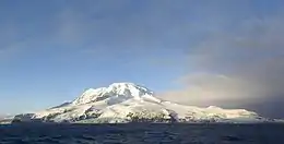 A view of the snow-capped Heard Island from a boat.