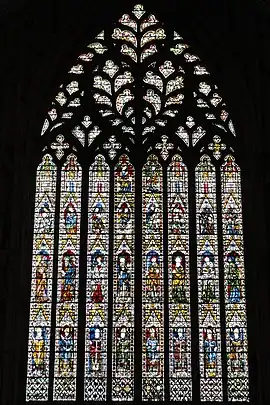 A very large window of eight lights rising to elaborate tracery in the form of a sacred heart