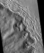 Hecates Tholus Ridges, as seen by HiRISE.  Ridges are to the west-northwest of Hecates Tholus.  The deepest ridge was measured to be about 50 meters high.