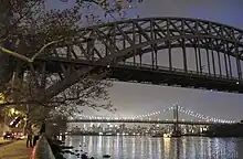 The Hell Gate Bridge and Triborough Bridge as seen from the park's waterfront at night