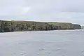 Cliffs and chambered cairn on Helliar Holm.