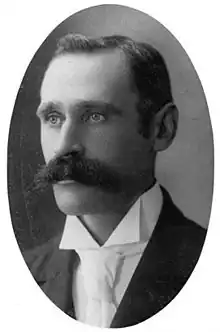 Black and white portrait of a man with moustache