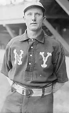 A black-and-white photograph of a man in a New York Islanders uniform