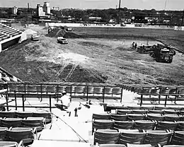 A black and white photograph showing a baseball field being built