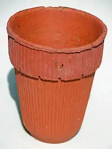 Herty turpentine cup, made of clay.  The hole is for nailing to a pine tree