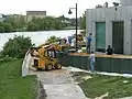 Using a skid loader to fill barriers.