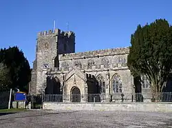 Stone building with square tower.