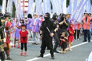 Three people in black costumes