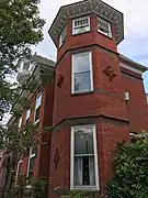 Brick Queen Anne-style residence.