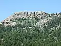 Horsetooth Rock, named for the profile of its east face. Hikers are visible on the summit.